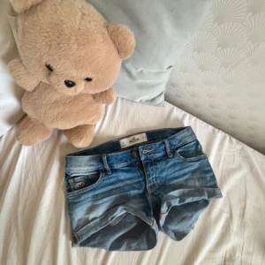 Blå jeansshorts från Hollister - Snygga blå jeansshorts från Hollister, storlek w23. Midjemått rakt över. 34 cm. 💕