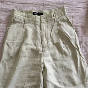 Ljusgröna linnebyxor från Zara - Snygga ljusgröna linnebyxor från Zara i storlek XS. Byxorna har hög midja, raka ben och klassiska fickor både fram. Perfekta för en chill och stilren look under varmare dagar.