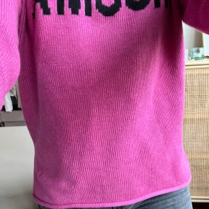 Rosa polotröja Zadig & Voltaire AMOUR - Cool rosa polotröja från Zadig & Voltaire med svart texten 'AMOUR' framtill. Tröjan är stickad i en mjuk blandning av ull och polyamid, har ribbad polokrage och en relaxed fit. Perfekt statement-piece för dig som gillar färg och att sticka ut.