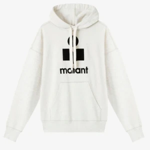 Vit hoodie från Isabel Marant - INTRESSEKOLL Vit hoodie från Isabel Marant med svart logotyp framtill. Tröjan har huva med snörning, känguruficka och långa ärmar. Oversized passform och tillverkad i mjuk bomull, perfekt för en chill och trendig look.