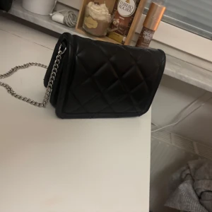 svart väska från stradivarius med silver kedja - Jätte fin svart väska från Stradivarius original pris:130kr💘inga defekter, har använts 2 ggr. passar till allt💝