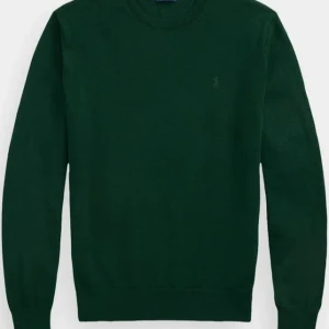 Mörkgrön stickad tröja från Polo Ralph Lauren - Snygg mörkgrön stickad tröja från Polo Ralph Lauren med diskret broderad logga på bröstet. Klassisk rund halsringning och långa ärmar. Perfekt för lager-på-lager och enkel att matcha med jeans eller chinos.
