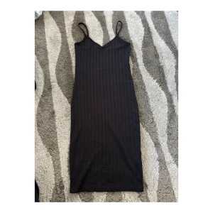 Stretchig klänning i strl XS - Svart, stretchig och åtsittande klänning i storlek XS. Använd endast ett fåtal gånger. Texturen syns på tredje bilden. SAMFRAKTAR om du köper flera varor samtidigt! 📦