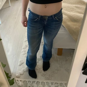 Blå jeans med bootcut - Säljer ett par snygga blå jeans med bootcut. De har en klassisk femficksdesign och en knappgylf. Perfekta för en avslappnad stil.har tyvärr inga fler bilder då dem ej passar