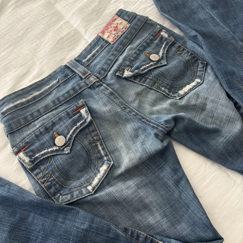 Säljer dessa superfina blåa jeansen med några slitningar från True Religion som jag köpte här på Plick. Jeansen har storlek 27, midjemåttet tvärsöver är 37cm och innerbenslängden är 74cm☺️Jeansen har inte blivit använda av mig! (Har tyvärr inga bilder med jeansen på då de är för små för mig). Farkut & Housut.