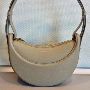 Polène  Numero Dix Edition Textured Olive  - The bag is made of textured calf leather  Comes with two different straps so that you can adjust the length for different crossbody or shoulder bag styles.  Size : 24 x 20 x 7.5 cm  The bag was used only a few times, like new condition.   The bag will be delivered with the original box and dust bag. 