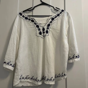 Blus med marinblått mönster  - En vit blus med marinblått mönster i strl M. Knappt använd och bra skick!