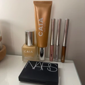 CAIA och NARS sminkset med foundation, highlighter och ögonskuggor - Säljer ett sminkpaket med produkter från CAIA och NARS. I paketet ingår foundation, flytande highlighter, tre flytande ögonskuggor från CAIA och en ögonskuggspalett från NARS. Foundation nyans 2W.  Alla är endast testade en gång. Förutom de flytande ögonskuggor a som inte är testade alls.