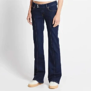 Paris Crease bootcut jeans mörkblå - Mörkblå bootcut jeans från 157, modell Paris Crease. Super låg midja och hel längd. Snygga kontrastsömmar och klassisk femficksdesign. Perfekta för dig som gillar 00-talsvibbar och markerad siluett.