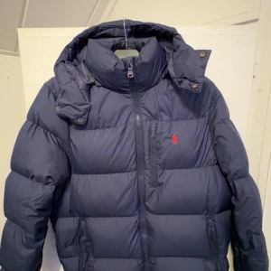 MarinBlå dunjacka från Polo Ralph Lauren  - Säljer en snygg blå dunjacka från Polo Ralph Lauren. Som är storlek M men passar för både M och S,knappast hunnit använda den. Kan gå ner i pris vid snabb affär
