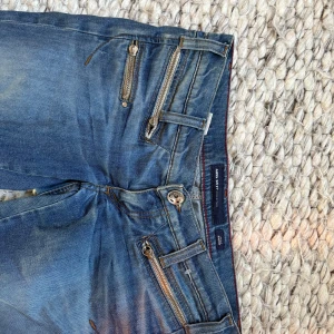 Blå raka lågmidjade jeans med dragkedjedetaljer från G-Star RAW - Perfekta för boots! Midjemåttet är ca 39 cm. 