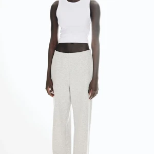 Vit ribbad croppad linnetopp från H&M - Säljer en vit croppad linnetopp från H&M med ribbad struktur. Toppen är ärmlös och har en rund halsringning. Perfekt för varma dagar eller som lager på lager-plagg.