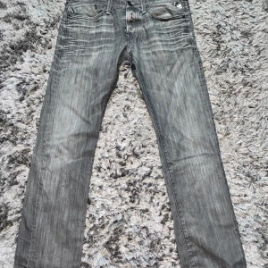 Replay grå jeansbyxor - Säljer ett par grå jeansbyxor från Replay med raka ben och klassisk femficksdesign. Byxorna har Replay-logga i metall på fickan , jeansen är knappt använda då de inte passar mig Storleken är 30/32 . Perfekta för dig som gillar stilrena och tidlösa jeans. Nypris på dessa jeans är 1299 kr , Priset kan diskuteras