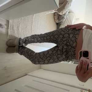 Ormmönstrade byxor - Säljer ett par asnice och unika, slutsålda byxor från weekday med ormmönster!! så coola!🩷🩷