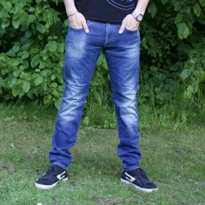 Replay Anbass  - Säljer ett par klassiska blå jeansbyxor med normal passform och raka ben. Jeansen har fem fickor, dragkedja och knapp i midjan. Snygg tvätt med lätt slitning på framsidan. Perfekta till sneakers och t-shirt. Modell Anbass 34/32