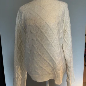 Vit stickad polotröja med kabelmönster - Säljer en vit stickad tröja