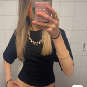 Svart kortärmad topp - Jättesnygg tröja från nelly💞 (som man knytter där bank med ett roset)💕💕