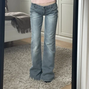 Lågmidjade jeans - Utavängda/bootcut modell i storlek 34, passar xs. De är 37,5cm i midjan tvärs över och 81cm i innerbenslängd. Superfint skick! Gråblå i färgen. Här av er om ni har några frågor! Lånade bilder för att säljer om de pga de inte passade mig 