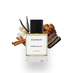ESSNCE Noble Eclat - Parfymflaska i glas med svart lock och stilren vit etikett. Doften Noble Eclat har inslag av vanilj, kanel, dadlar och träiga noter. Flaskan är genomskinlig och vätskan är ljusgul. Perfekt för dig som gillar varma, kryddiga och söta dofter.