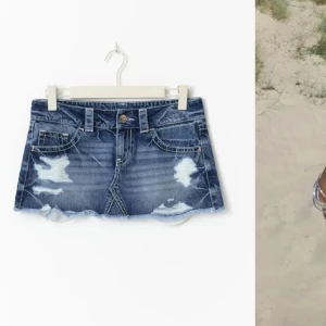 Blå jeanskjol med slitningar - Snygg kort jeanskjol i blå denim med slitna detaljer och fransig nederkant. Klassisk femficksmodell med knapp och dragkedja framtill. Perfekt för en avslappnad och trendig look. Stl xs, från Gina tricot. Nästan helt oanvänd 