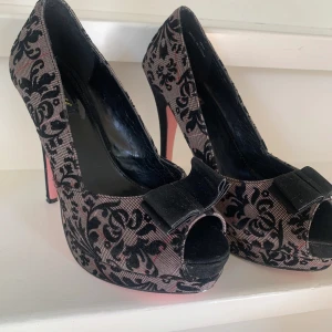 Cunty pin up couture pumps högklackat - Säljer mina as snygga pumps från Pin Up Couture med svart sammetrosett framtill, öppen tå och hög klack. Är i storlek 39 men passar mig med 38 också (endast litet glapp) 💕