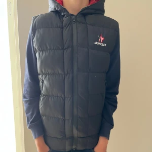 Moncler väst - Moncler väst säljes, Västen är röd inuti och har moncler text inuti som följs jämte dragkedjan, Moncler västen Kan inte garantera äktehet, kan bytas också, skriv vid minsta funderingar osv🤗
