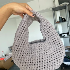 Brungrå virkad handväska - Superfin handväska i gråbrunt, virkad i ett grovt garn som ger en chunky och trendig look. Unik accessoar som lyfter vilken outfit som helst. Pris kan diskuteras. Kan mötas upp och skicka🫶🏼