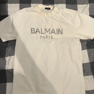 Balmain T-shirt - Helt ny oanvänd balmain T-shirt som scannar. Alla tags finns kvar och de medföljer med tröjan. Skick 10/10., storlek M passar L.