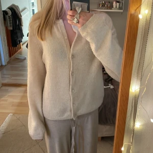 Beige kofta från H&M - Mysig beige kofta från H&M med knappar framtill. Koftan har långa ärmar och passar till det mesta. Storlek Xs