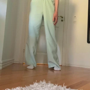 Ljusgröna linnebyxor  - Säljer ett par snygga ljusgröna linnebyxor med resår i midjan från Vero Moda. Byxorna har raka ben, materialet känns mjukt och lätt, och färgen är pastellgrön. Jag är 173 lång, och längden passar perfekt. 