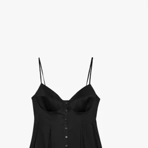 Svart korsett-topp med knappar - Supersnygg svart korsett-topp med tunna axelband och knappar hela vägen framtill. Toppen har markerade kupor och lätt utsvängd nederdel som ger en cool siluett. Perfekt att styla med jeans eller kjol för en trendig look.