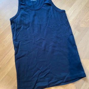 Svart linnetopp från Jack & Jones - En klassisk svart linnetopp från Jack & Jones med rund halsringning. Tillverkad i mjuk bomull som känns skön mot huden. Perfekt för en avslappnad stil och enkel att matcha med jeans eller shorts.