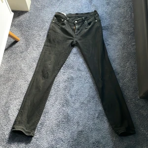 Svarta Levi's 511 Premium jeans W33 L34 - Svarta Levi's 511 Premium jeans med klassisk femficksdesign och raka ben. Jeansen har en snygg, smal passform och är tillverkade i slitstarkt jeanstyg. Perfekta för dig som gillar en clean och tidlös look.