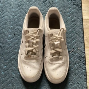 Vita Nike Air Force 1 sneakers - Säljer ett par klassiska vita Nike Air Force 1  med bra kvalite och dom är endast använda 5 gånger. Dom är lite creasade men vid köp kan jag slänga in ett par creasskydd. Storlek 38,5
