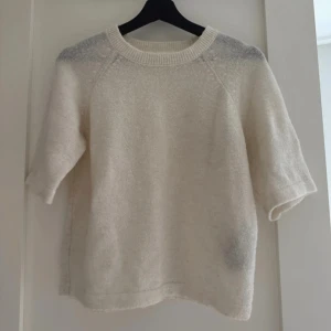 Vit stickad tröja från Selected Femme - Säljer en vit stickad tröja från Selected Femme i storlek XS. Tröjan har rund hals, ribbad kant och halvlånga ärmar. Enkel och clean design som är lätt att matcha med jeans eller kjol. Perfekt för dig som gillar mjuka och sköna material.