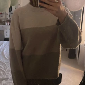 Randig beige och brun stickad tröja H&M - Mysig stickad tröja från H&M i storlek XS. Tröjan har breda blockränder i olika nyanser av beige och brun, rund halsringning och långa ärmar. Perfekt för lager-på-lager och chill dagar. Enkelt att matcha med jeans eller kjol.