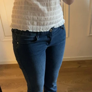 Mörkblå lågmidjade bootcut jeans - Säljer ett par lågmidjade mörkblå jeans med bootcut-modell från ONLY. Storlek Mx34 motsvarar 29x34 tum. 86cm i innerbenslängd. Jag är 175 cm. De är även mycket mjuka i tyget och är sköna. Har används en enstaka gång och säljer p.g.a kommer inte till användning. Hör av dig vid frågor eller interesse💞
