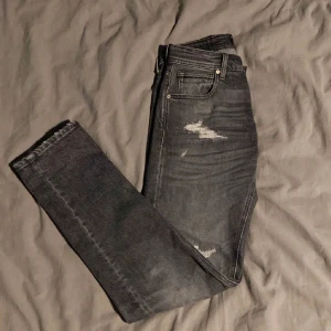 Replay jeans (HELT NYA) - Length 30 o waist 27.        Säljer ett par svarta jeans från Replay med slitningar på både fram- och baksida. Jeansen har fem fickor, raka ben och klassisk knappgylf.  Skick 10/10. Passar 170-175cm