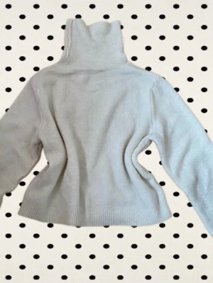 Vit stickad polotröja - Mysig vit stickad tröja med polokrage och långa ärmar. Säljer för att den är för liten för mig. Original pris 290 kr.