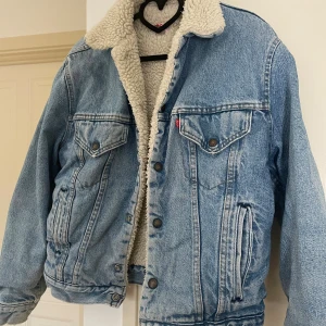 Levi's fodrad jeansjacka  - Ljusblå jeansjacka från Levi's med teddyfoder. Perfekt till höst/vinter. Storlek 40. Fint skick