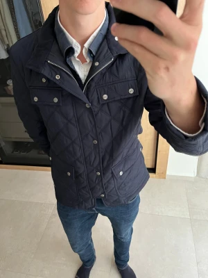 Quiltad Jacka från DR&N - Helt ny quiltad jacka från DR&N 😊                          —————————————————————————                                                              📐| Storlek: M                                                          👖| Märke: DR&N                                                     🔎 | Skick: Nyskick                                                  ✍🏻 | Skriv om du har några frågor
