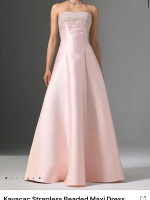 Helt ny balklänning - Drömmig ljusrosa balklänning från Bellabarnett med axelbandslös design och pärlbroderad överdel. Klänningen har snörning i ryggen. Endast testad:) Lappar kvar, Passar S/M💕