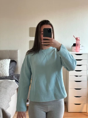 Ljusblå stickad tröja med bred mudd - Mysig ljusblå stickad tröja med rund halsringning och bred ribbstickad mudd vid ärmslut och nederkant. Tröjan har en ganska rak passform. Bild 2 visar färgen bäst!💕💕Nypris 600kr