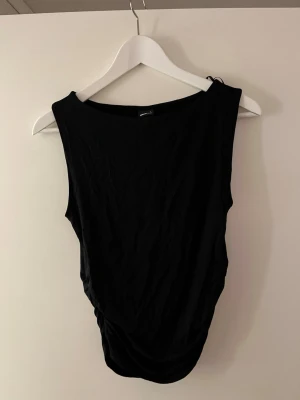 Svart ärmlös linnetopp - svart linnetopp med scrunch på sidorna. Aldrig använd