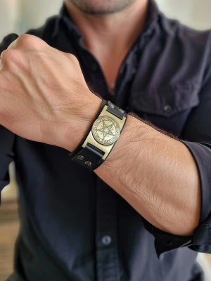 Armband vintage viking - Svart läderarmband med ett detaljerat vikingmotiv i metall. Armbandet har justerbara tryckknappar för att passa olika handledsstorlekar. Perfekt för den som gillar en unik och stilren accessoar. Storlek 23 cm långt. Bredd 3 cm.