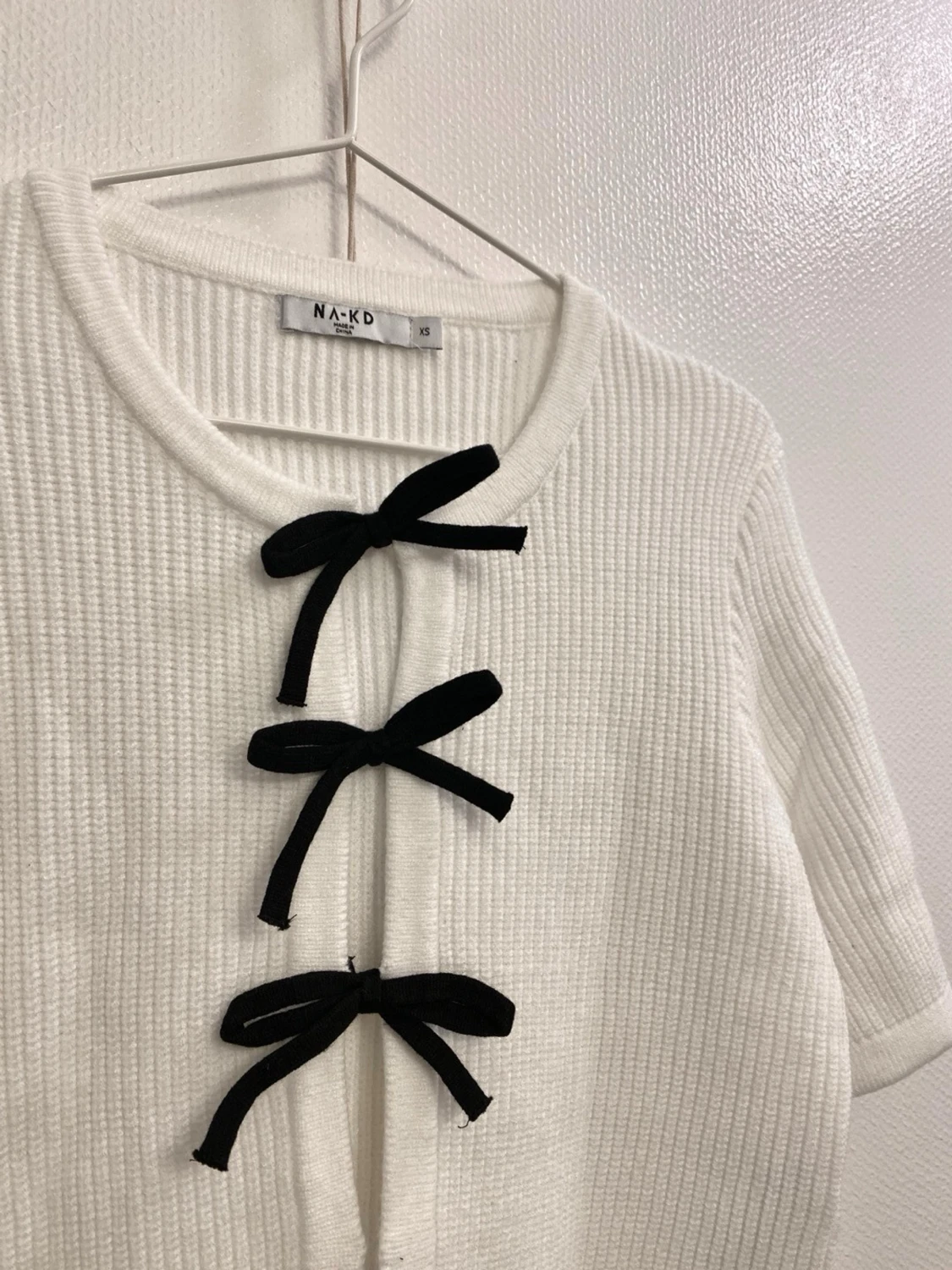 Vit kofta med svarta rosetter  - 1