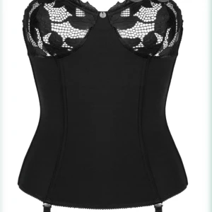Svart korsett med spetsdetaljer - Säljer en svart korsett med snygga spetsdetaljer upptill och markerad midja. Toppen har bygel och transparent spets över bysten för en extra cool look. Band för att knäppa fast ”strumpor”. Perfekt för dig som vill ha något unikt och edgy i garderoben.