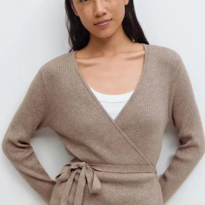 Omlottkofta  - Supermjuk beige omlottkofta i ribbstickad kvalitet från Gina Tricot. Koftan har långa ärmar, v-ringning och knytband i midjan för en snygg passform. Perfekt att slänga på sig över ett linne eller t-shirt.