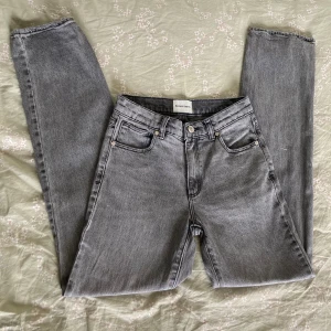 Grå Abrand Jeans A '95 Mid Straight - Säljer ett par grå jeans från Abrand Jeans, modell A '95 Mid Straight. De har klassisk femficksdesign, raka ben och midwaist. Lite slitningar längst ned på byxorna (se bild 5) och liknande slitningar på framfickorna, men inget man tänker på 💗Innerbenslängd: 73cm, midjemått (rakt över): 31cm