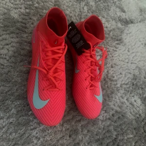 Nike rosa fotbollsskor med snörning - Helt oanvönda storlek 43. Kommer med låda och påse